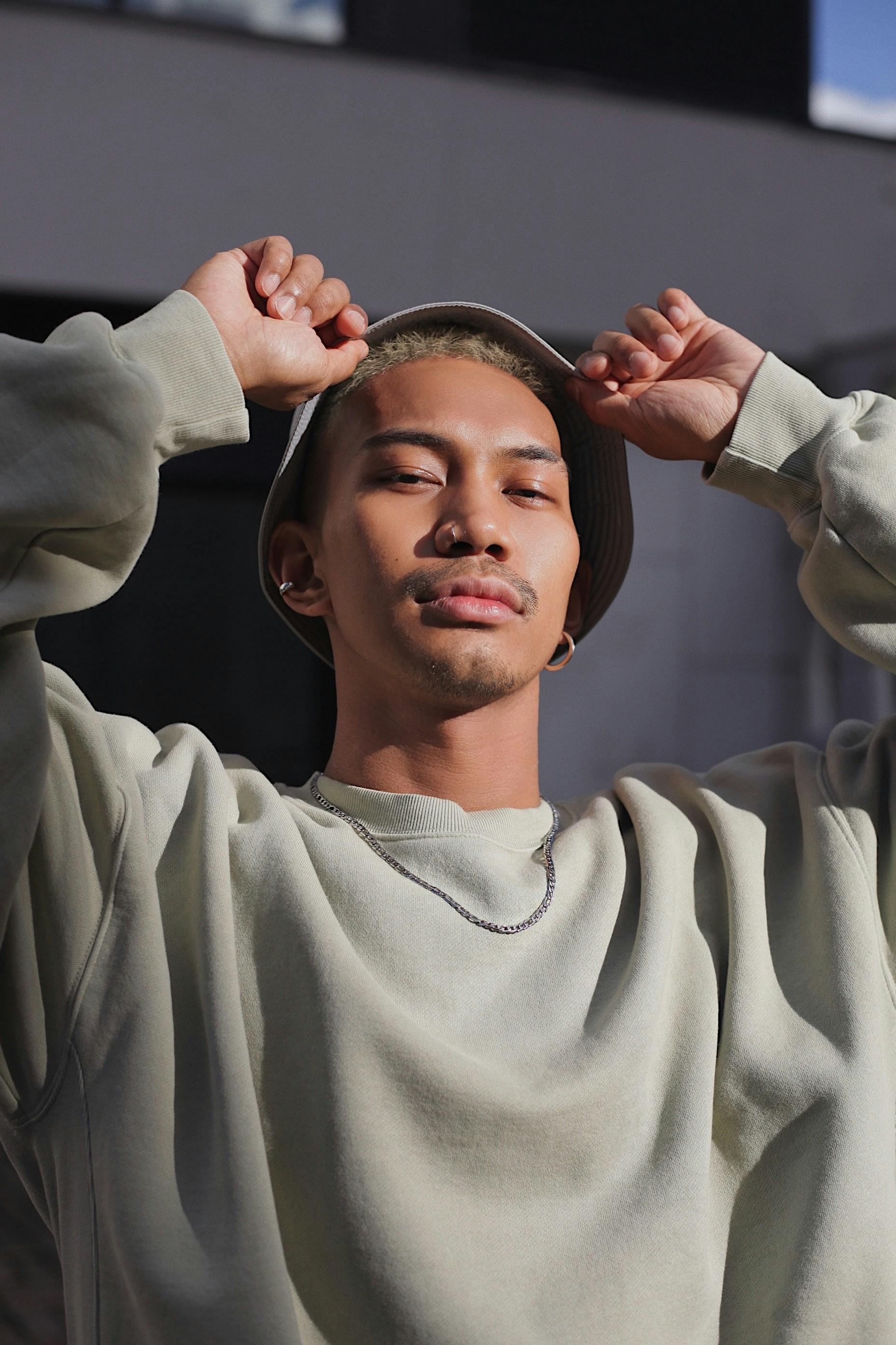 Image of a man wearing a beige bucket hat.