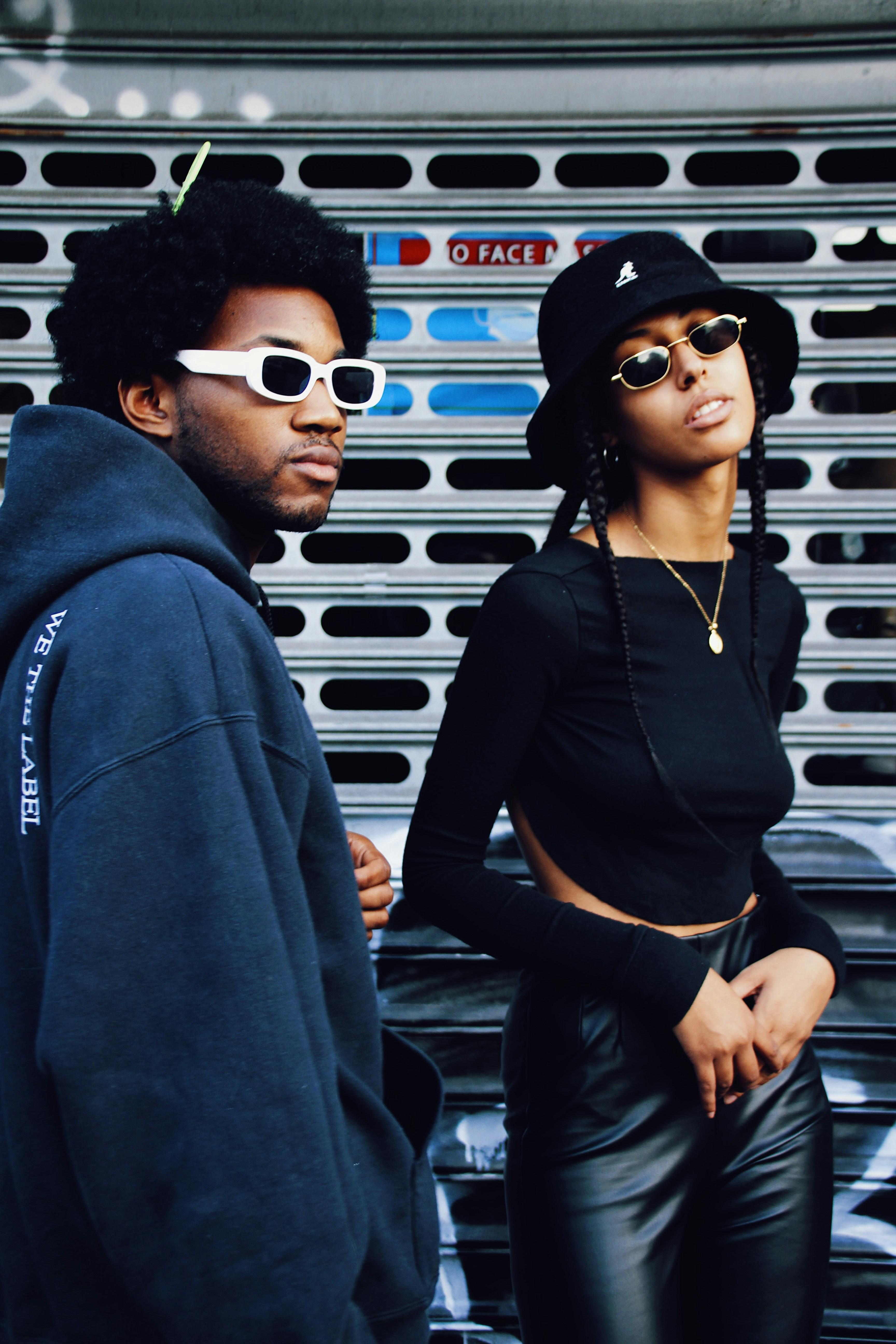 Image of a man and a woman wearing sunglasses.